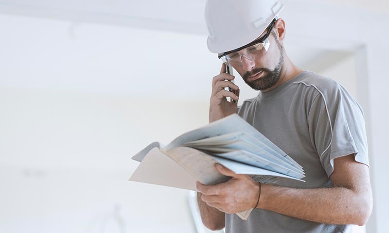 Contractor Reviewing Notes